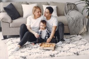 Family with Pizza on Rug