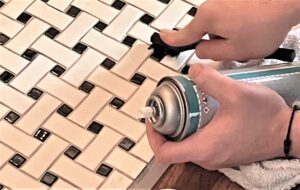 Tech scrubs grout of vintage tile floor.