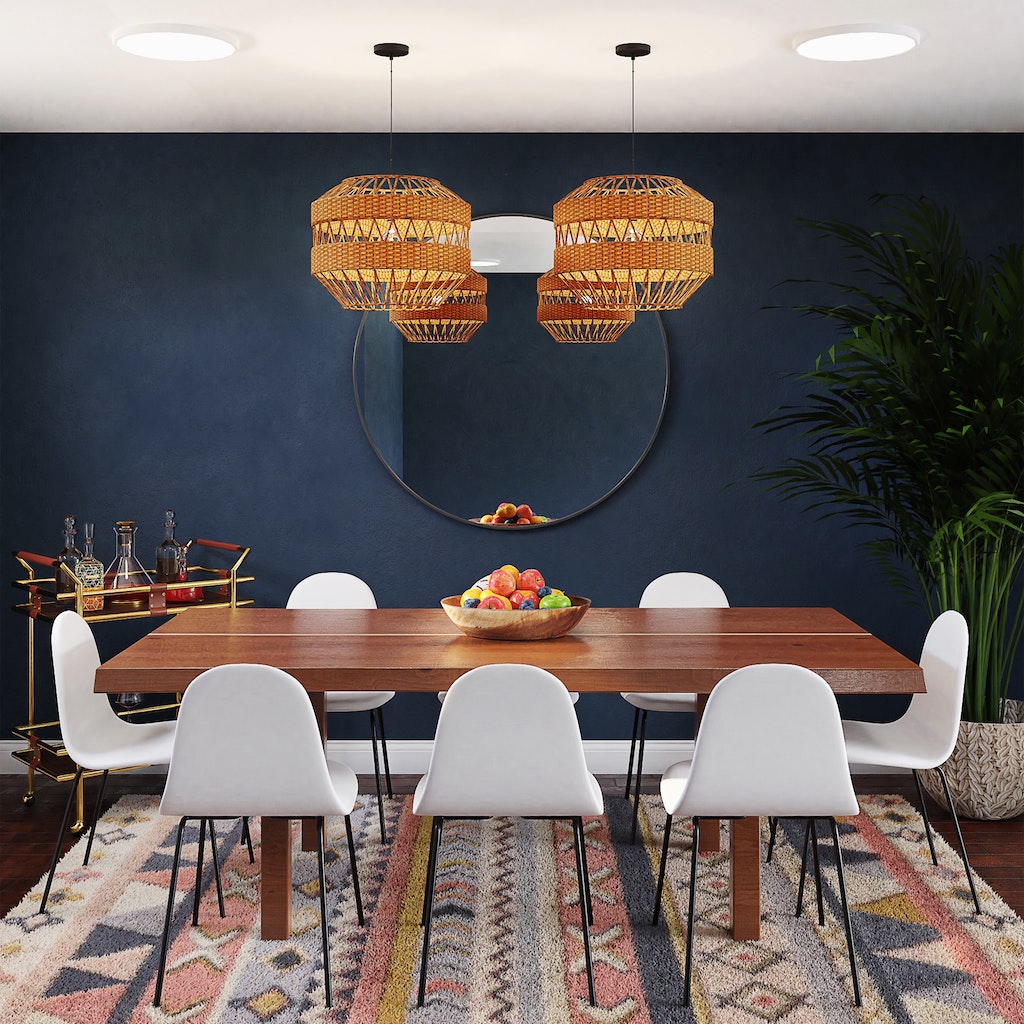 A dramatic navy blue dining room with a vibrant patterned rug.  Synthetic rugs are easily damaged by oil - whether food-based or automotive, but nylon may be the best rug material for a dining room rug.