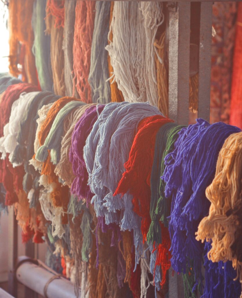 Colorful wool yarns are knotted to create stunning handmade textiles.
