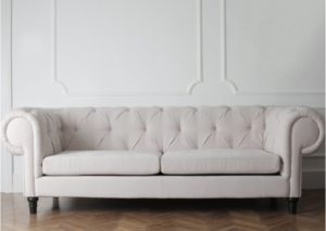 The longer sofas (like this ivory Chesterfield) live in your home, the more likely they will need an upholstery cleaning.