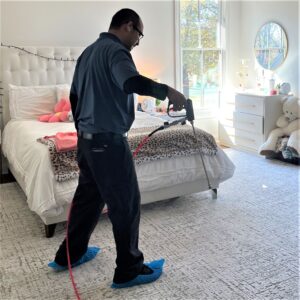 Pro-Care Technician applies stain protection to area rug