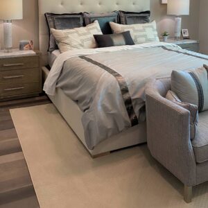 Queen Bedroom with cut and bound cream carpet.