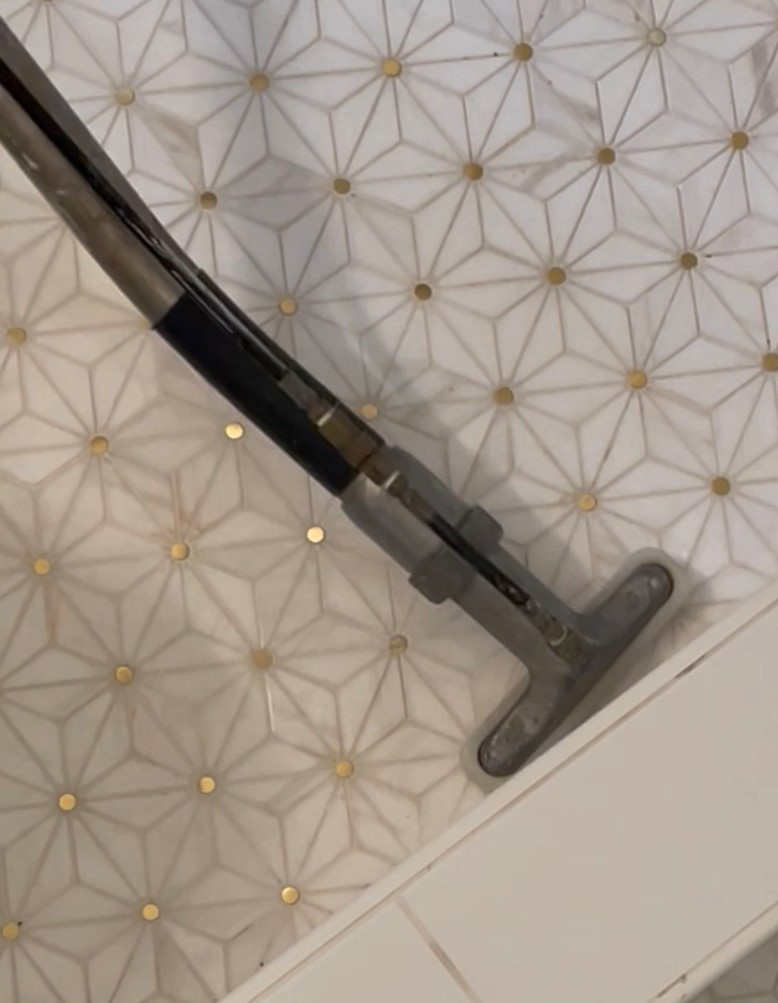 Closeup of cleaning designer tile.
