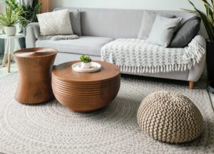 White living room featuring pouf and area rug.