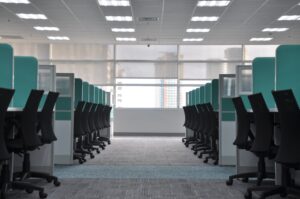 Modern cubicles in rows shown on commercial carpet.