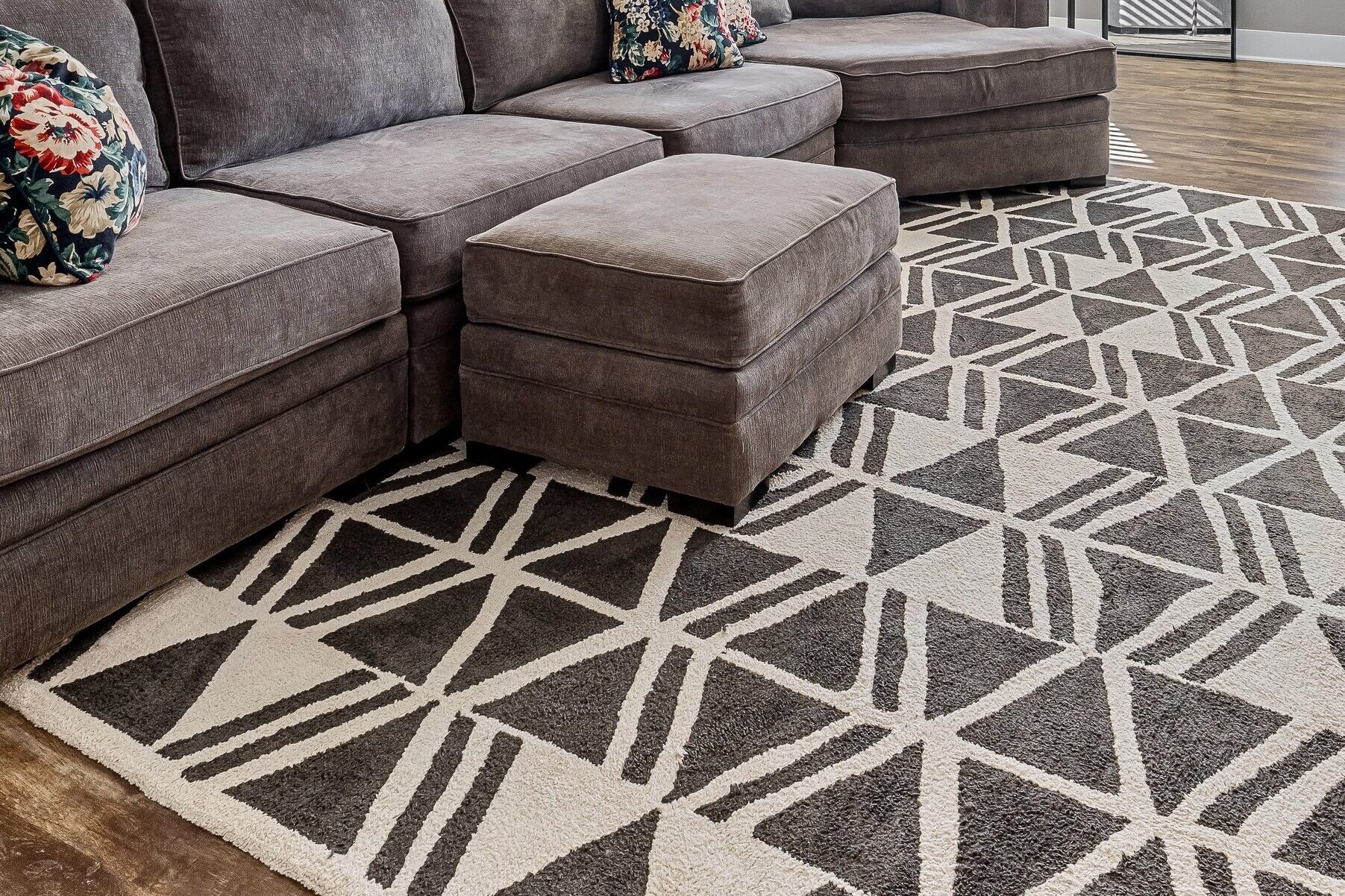This eclectic room gets drama from a top ten rug trend, the large-scale geometric rug.