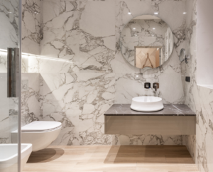 Large format stone-look surfaces are on-trend to create huge drama in a simple bathroom.