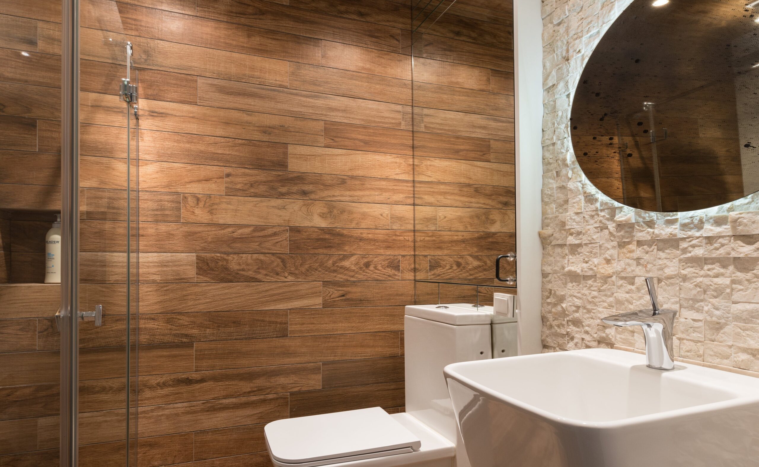 Natural tile motifs, like this wood pattern, warm up a white bathroom.
