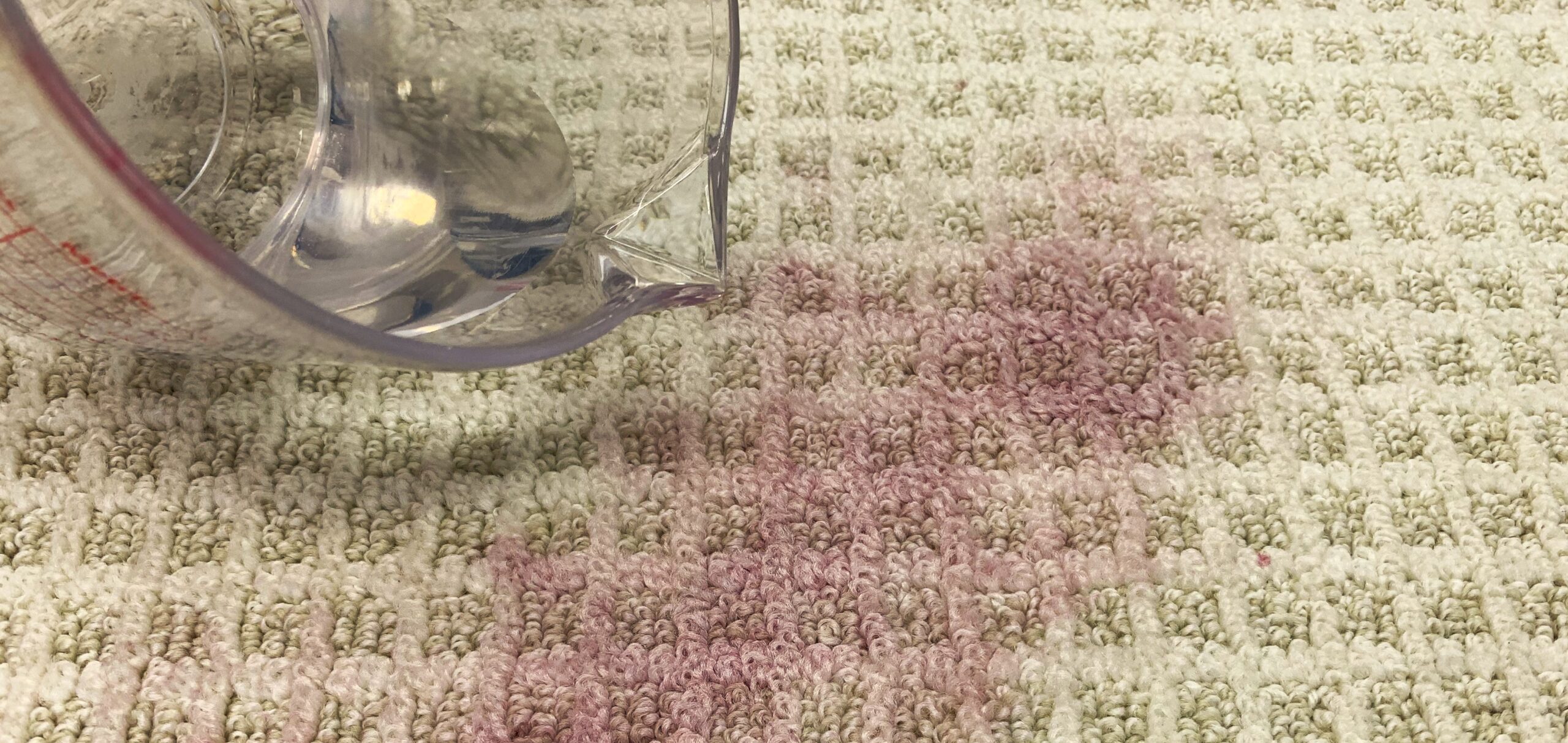 Close-up of water over lingering wine stain.
